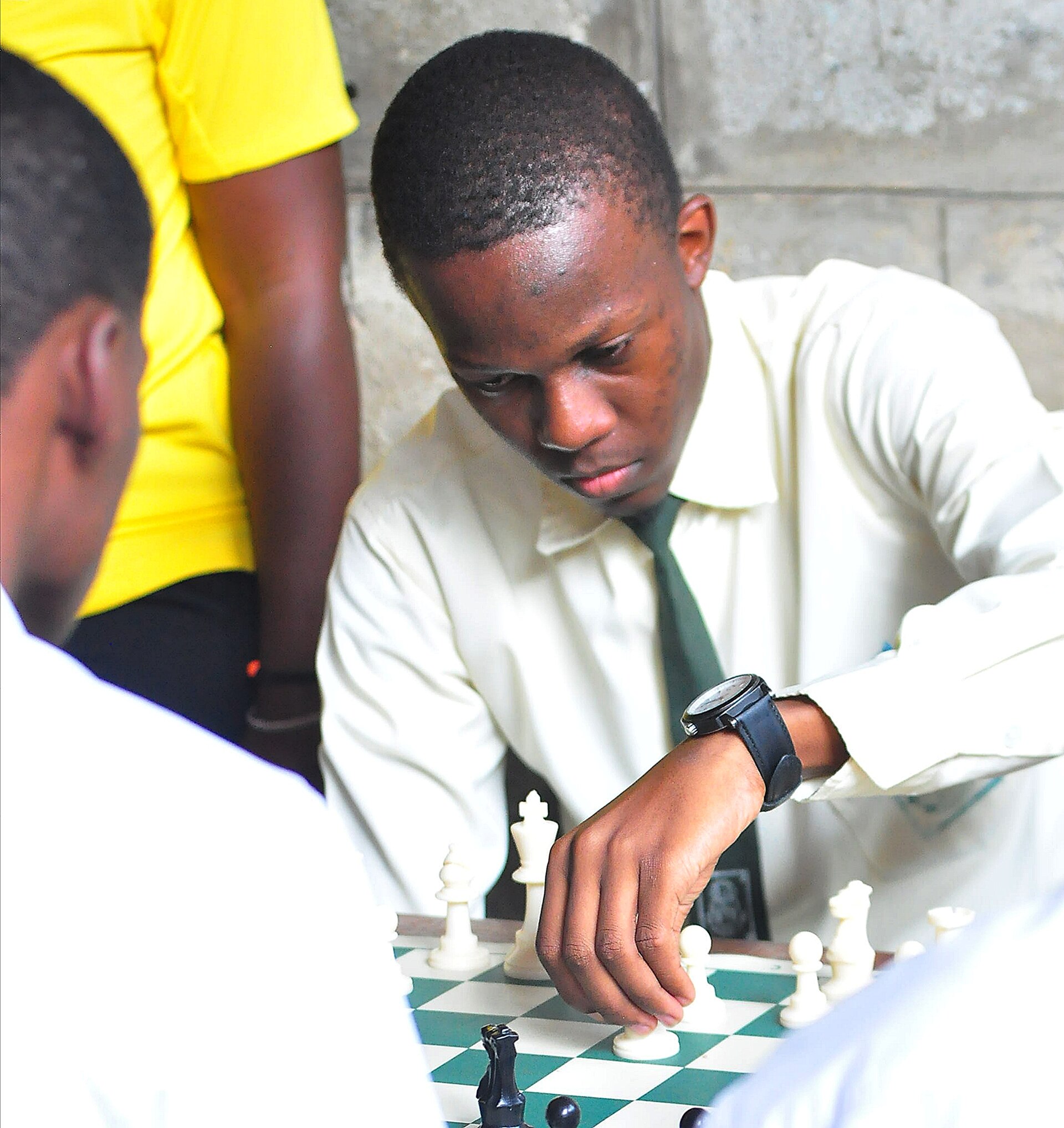 A student concentrating on a chess match