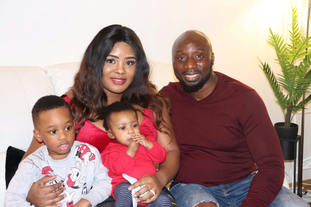 Parents with their two young children at home